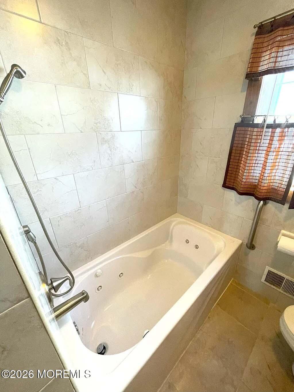 207 Bay Boulevard Lavallette, NJ 08735 - Photo 21 of 62 a bathroom with a tub sink and a mirror