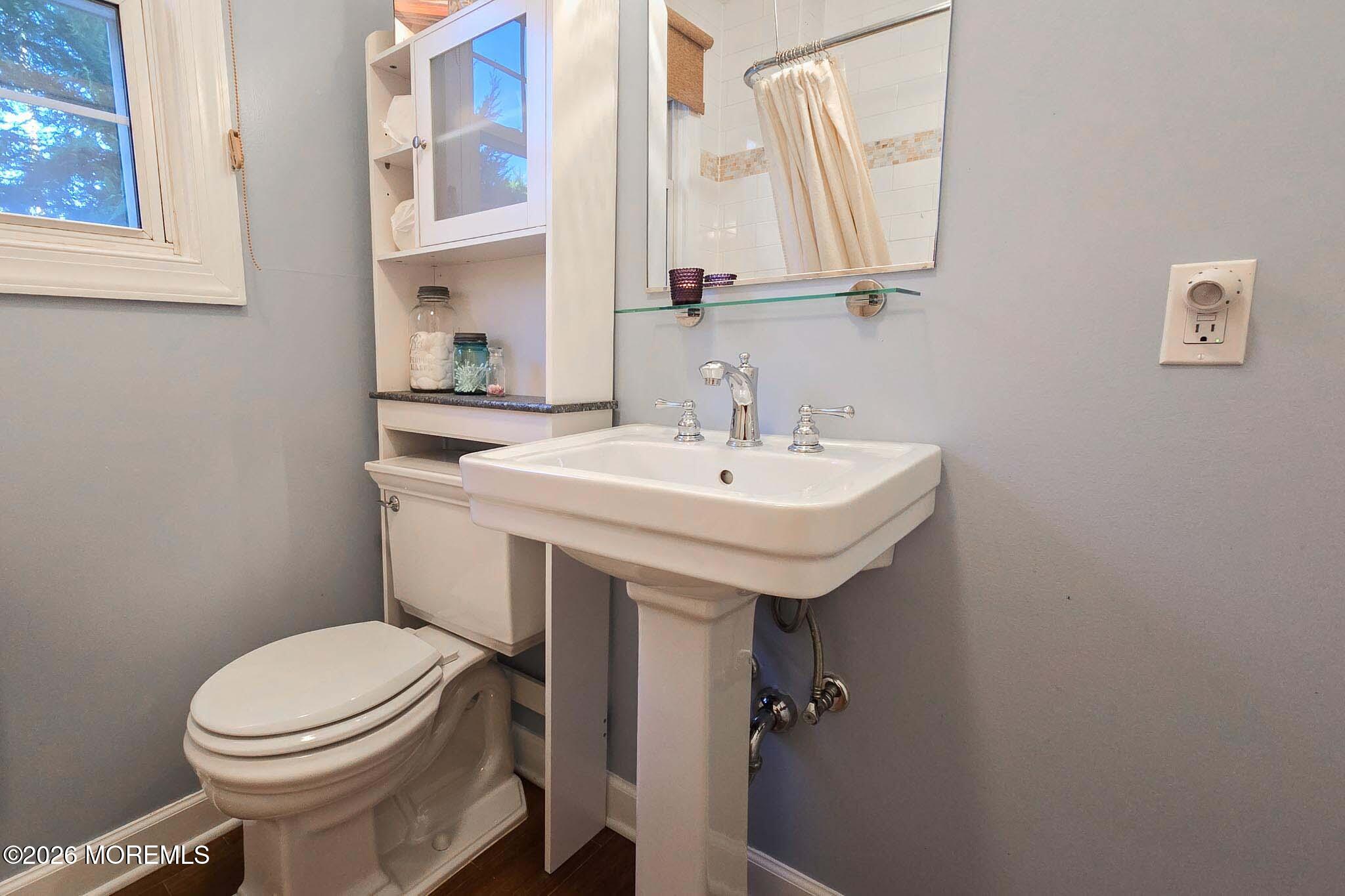 207 Bay Boulevard Lavallette, NJ 08735 - Photo 33 of 62 a bathroom with a sink a toilet and mirror