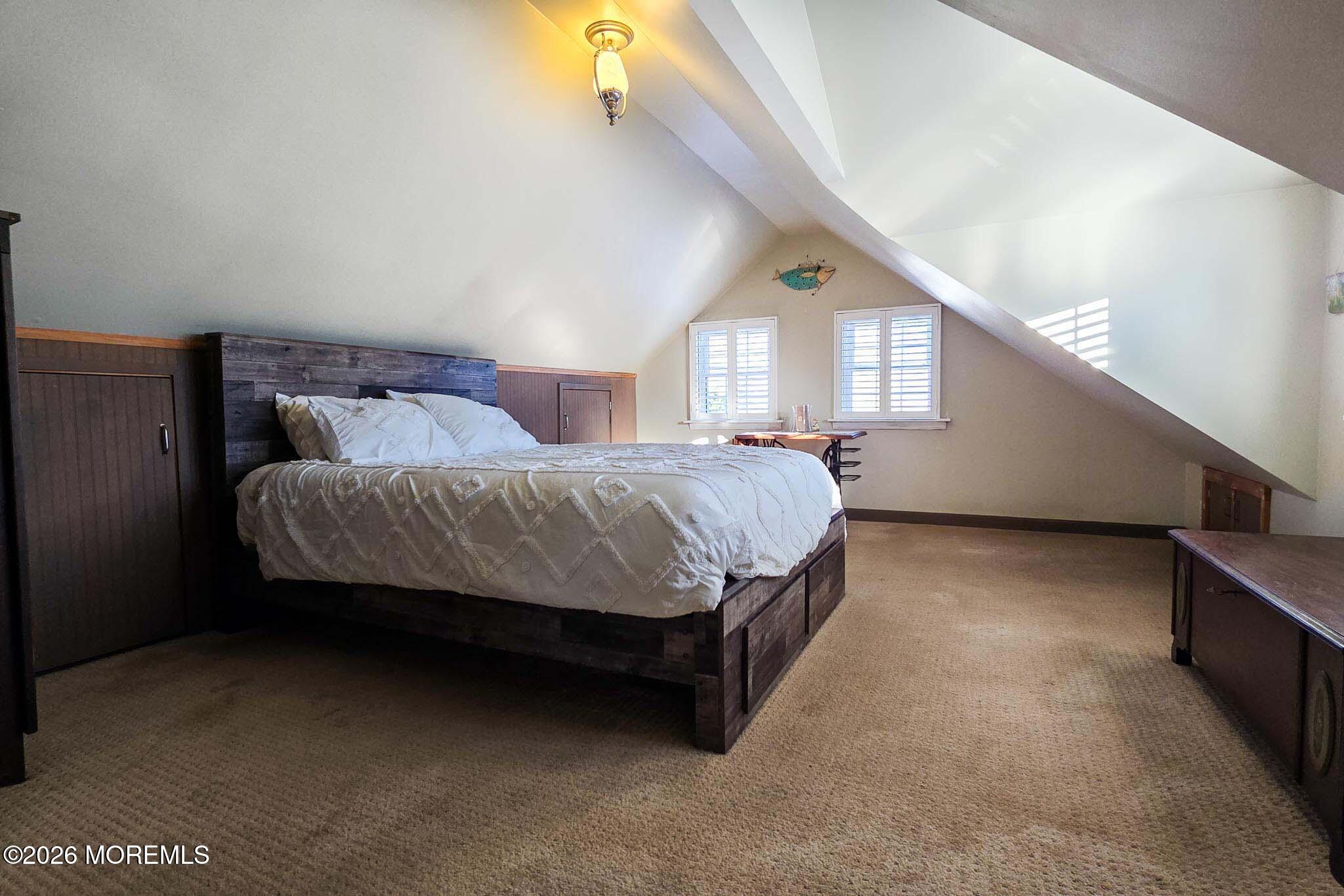 207 Bay Boulevard Lavallette, NJ 08735 - Photo 40 of 62 a bedroom with a bed and a night stand next to a window