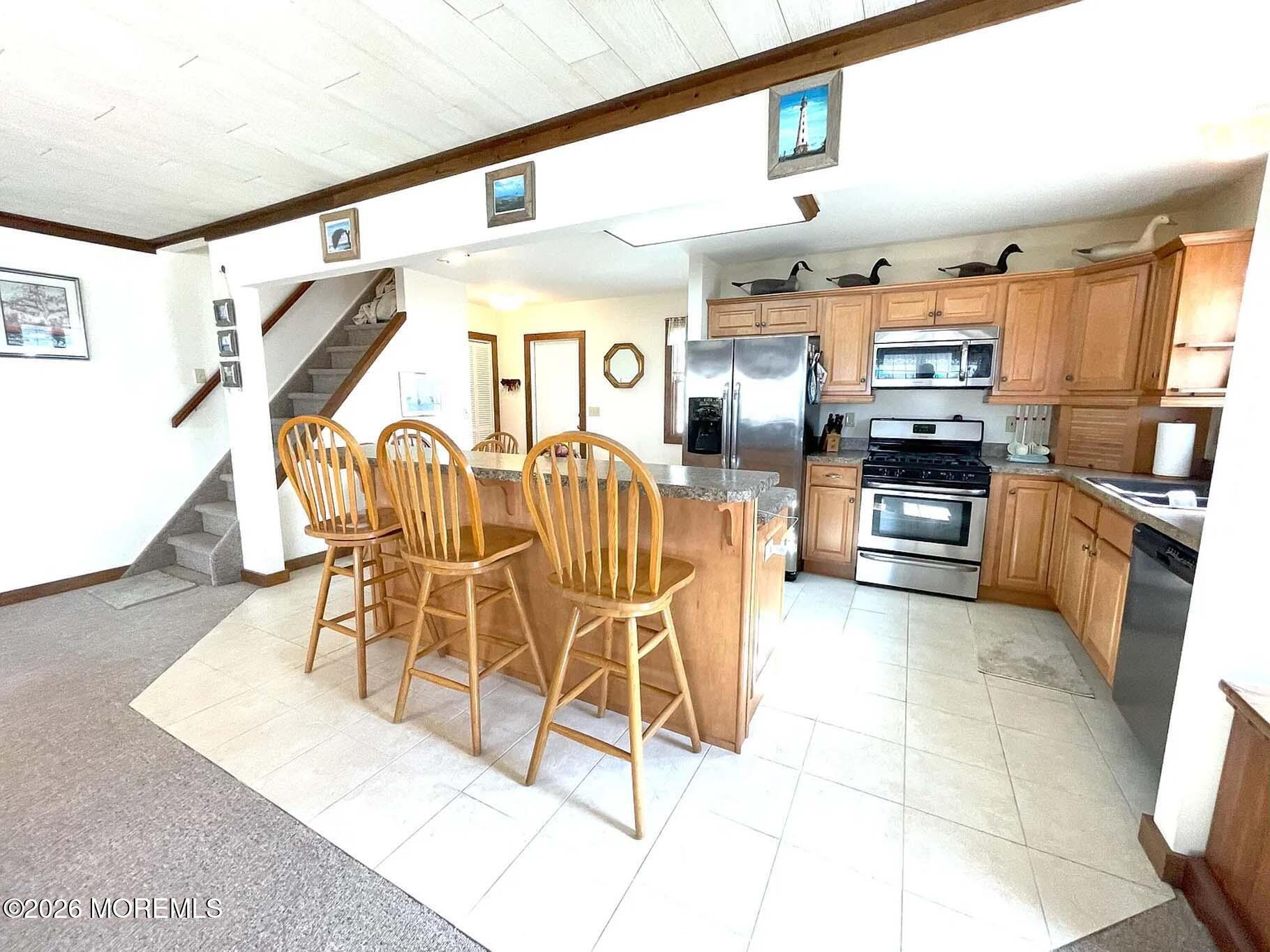 207 Bay Boulevard Lavallette, NJ 08735 - Photo 9 of 62 a kitchen with stainless steel appliances kitchen island granite countertop a stove and cabinets