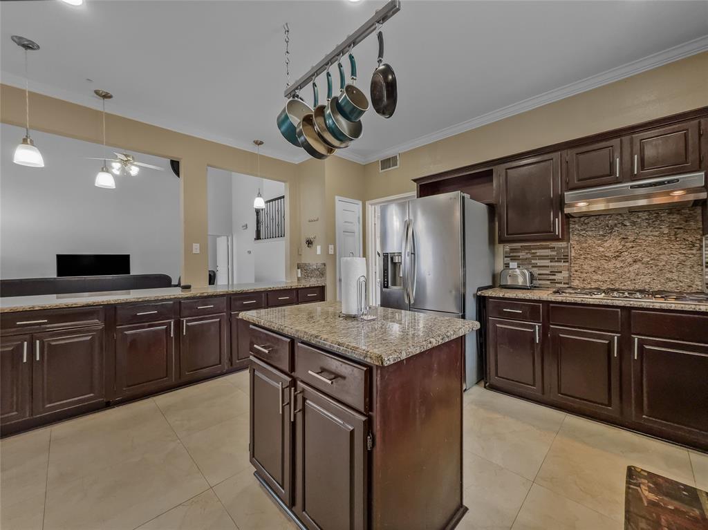 2317 Wellesly Road Rowlett, TX 75089 - Photo 3 of 39 a kitchen with stainless steel appliances granite countertop a sink stove and refrigerator