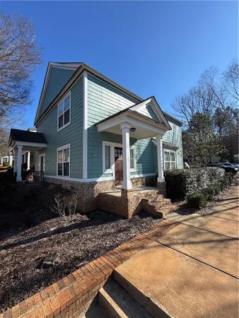a front view of a house with cars parked