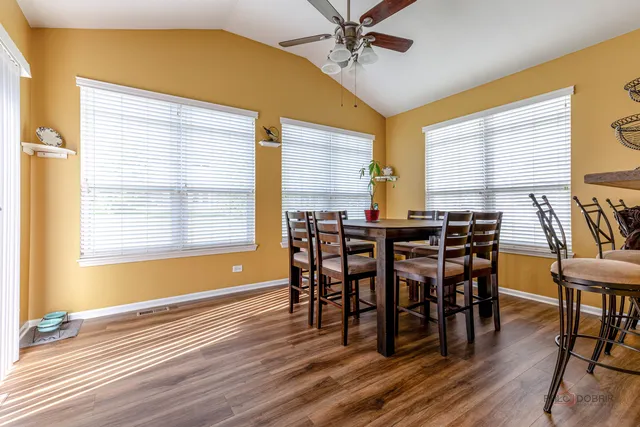 a view of a dining room with furniture and wooden floor
