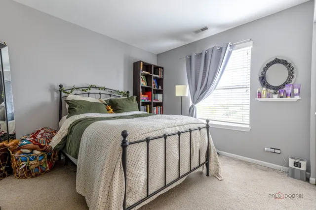 a bed sitting in a bedroom next to a window
