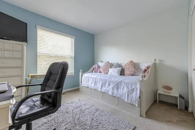 a bedroom with a bed and a chair