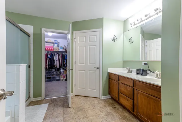 a bathroom with a mirror a sink and shower