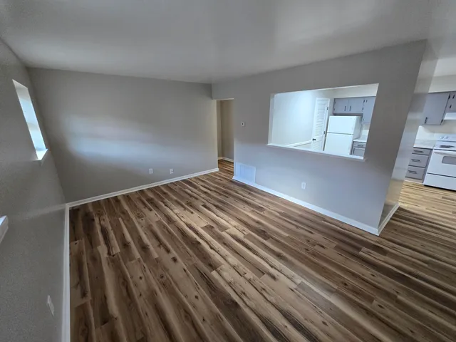 a view of an empty room and wooden floor