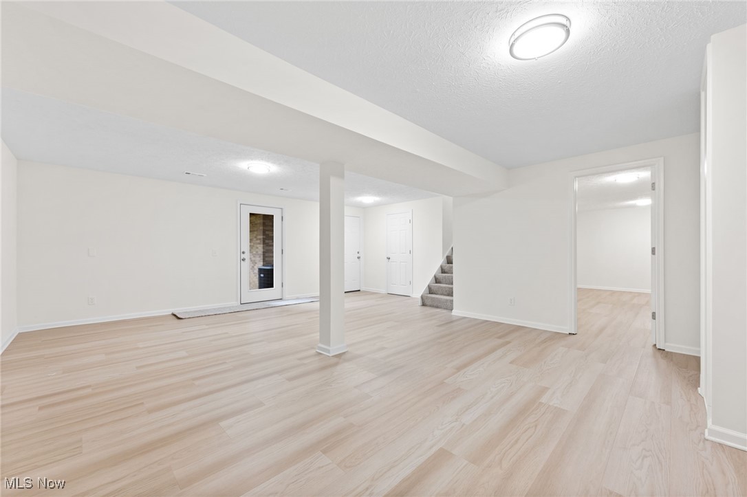 4098 State Road Medina, OH 44256 - Photo 19 of 41 Basement featuring light hardwood / wood-style flooring and a textured ceiling