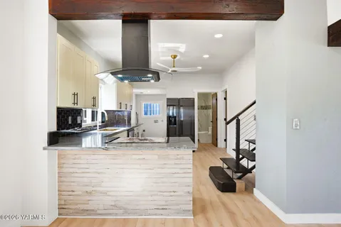 a view of living room with furniture and wooden floor