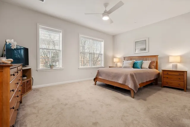 a bedroom with a bed and a tv on the dresser