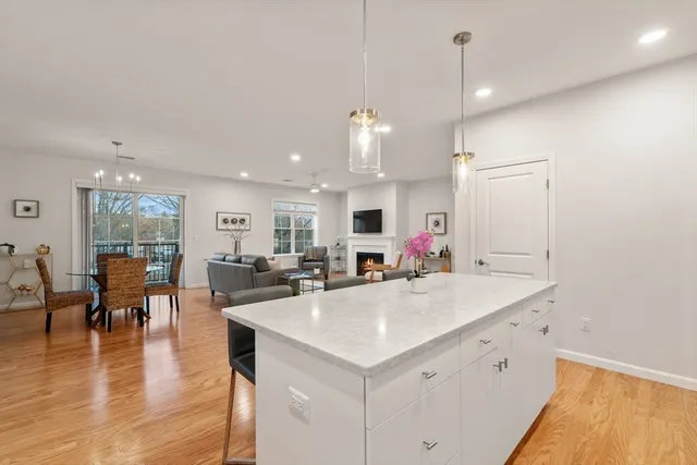 a kitchen with a sink appliances and wooden floor