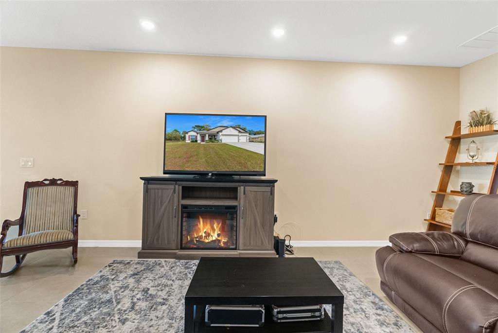 6283 Grapewood Road Spring Hill, FL 34609 - Photo 13 of 41 a living room with furniture and a fireplace