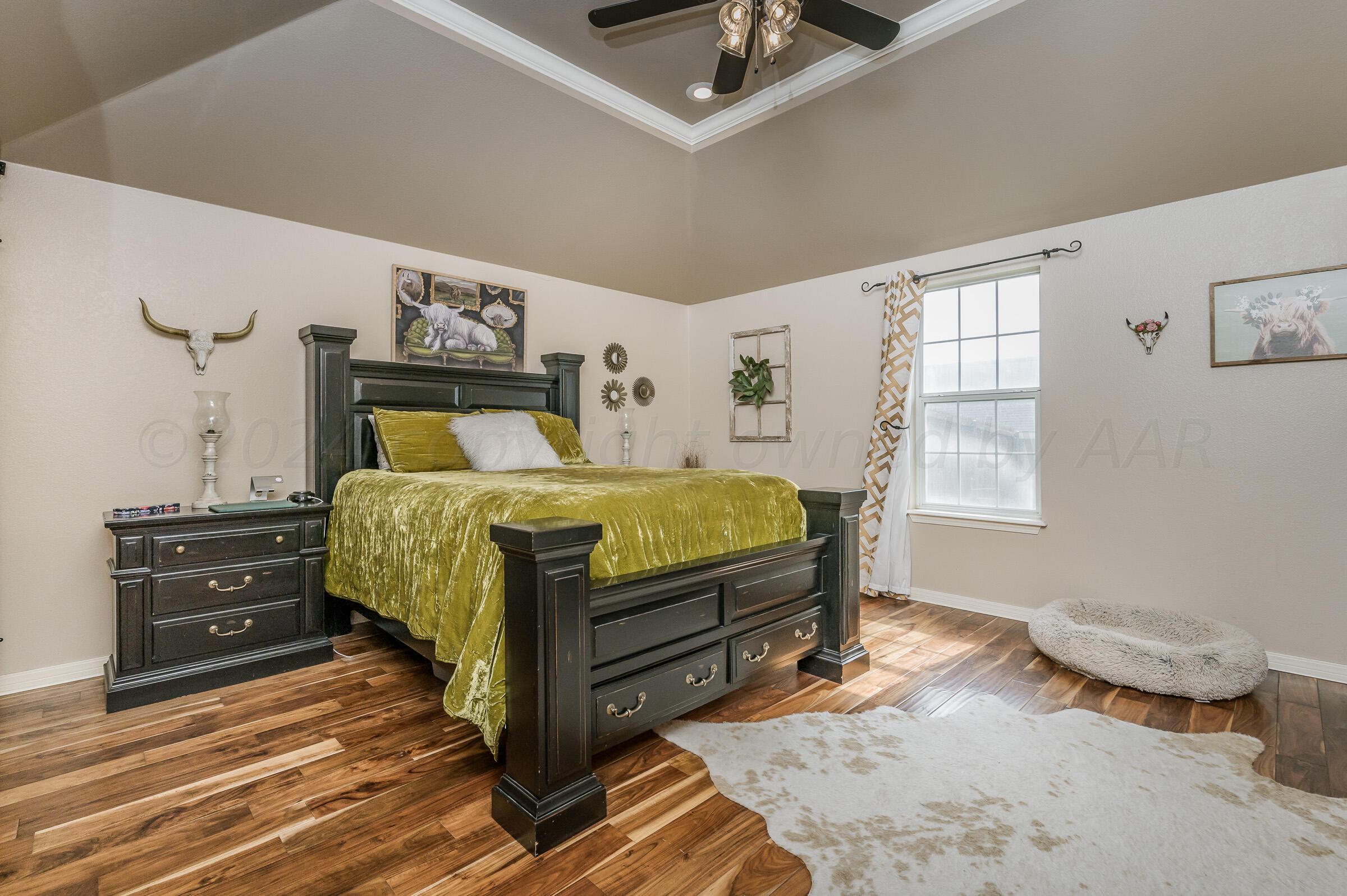 8921 Greyhawk Road Amarillo, TX 79119 - Photo 13 of 56 a bedroom with a bed and cabinets