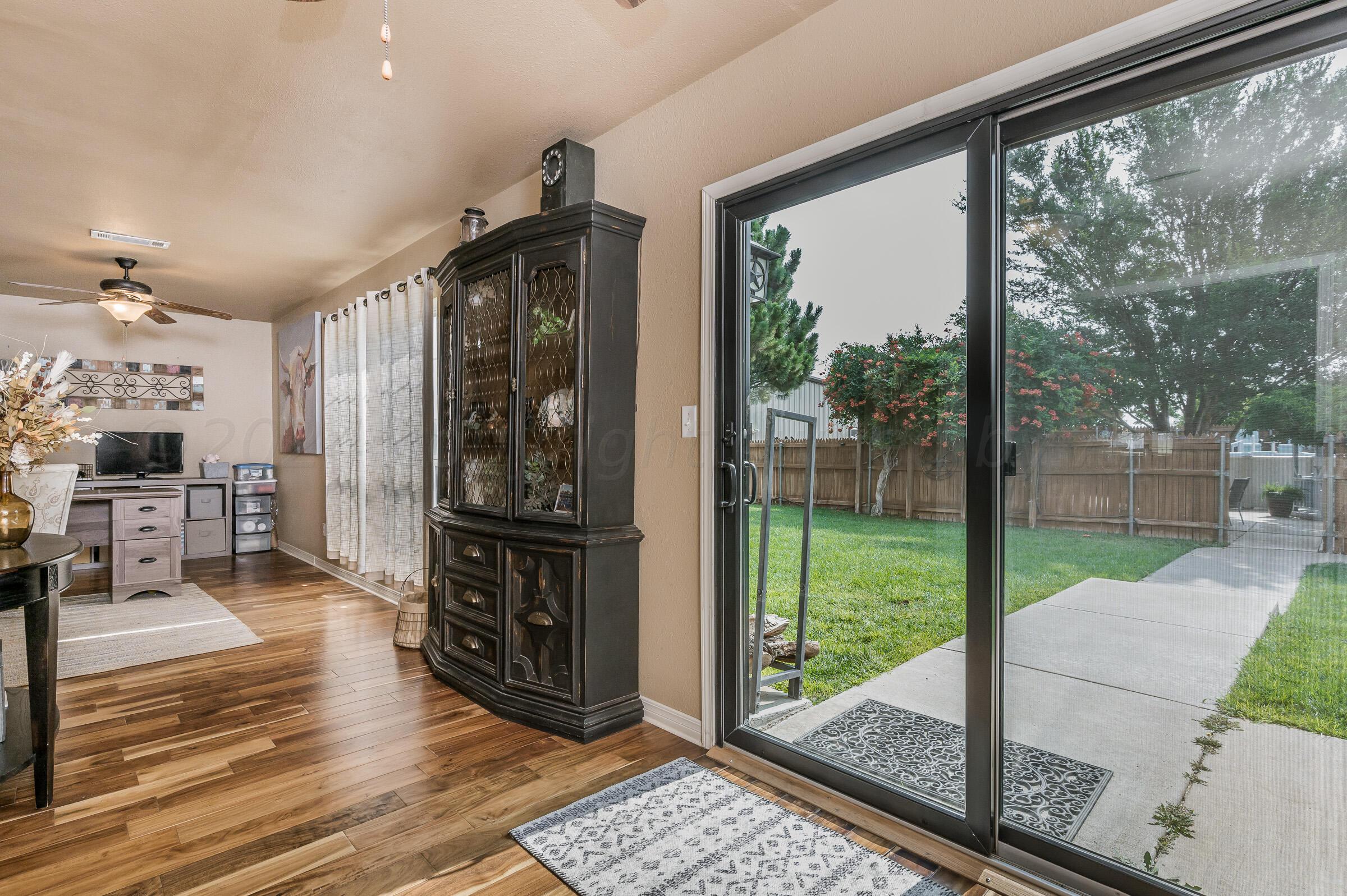 8921 Greyhawk Road Amarillo, TX 79119 - Photo 16 of 56 a view of a living room and a floor to ceiling window