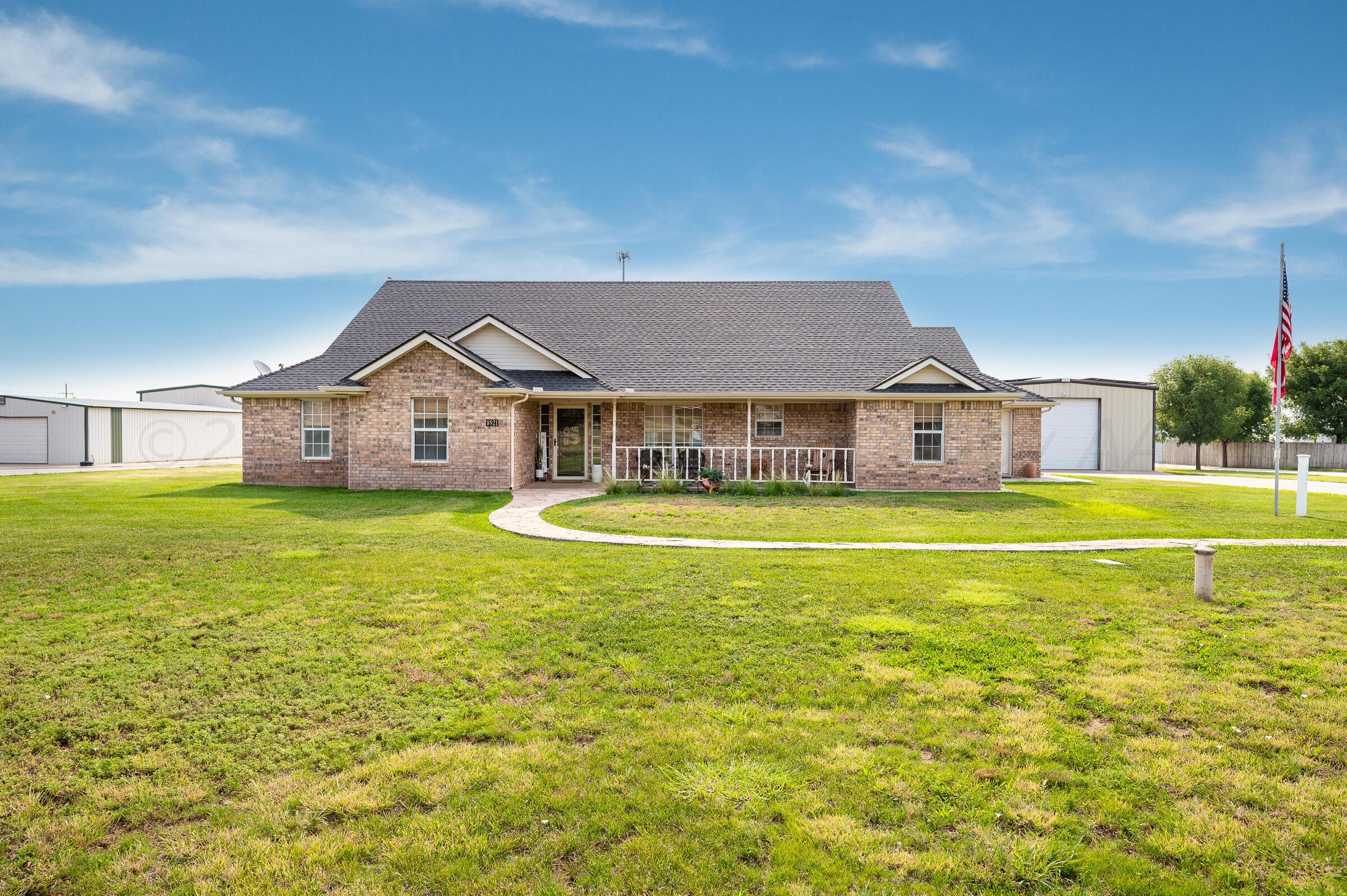8921 Greyhawk Road Amarillo, TX 79119 - Photo 2 of 56 a front view of a house with swimming pool