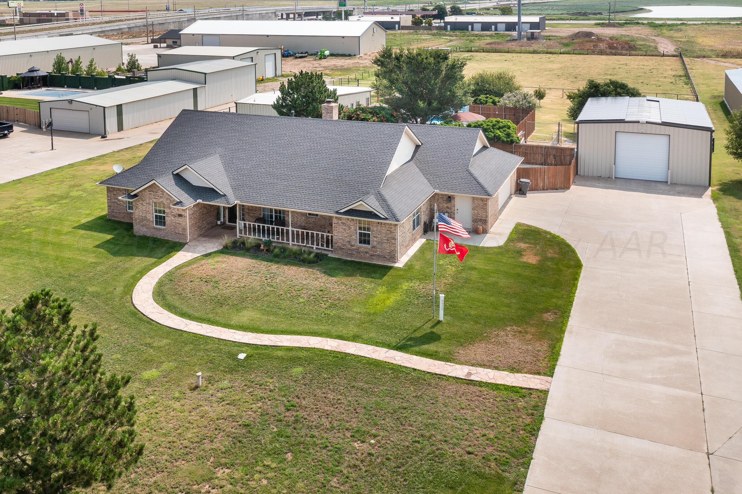 8921 Greyhawk Road Amarillo, TX 79119 - Photo 27 of 56 an aerial view of a house with a garden and swimming pool