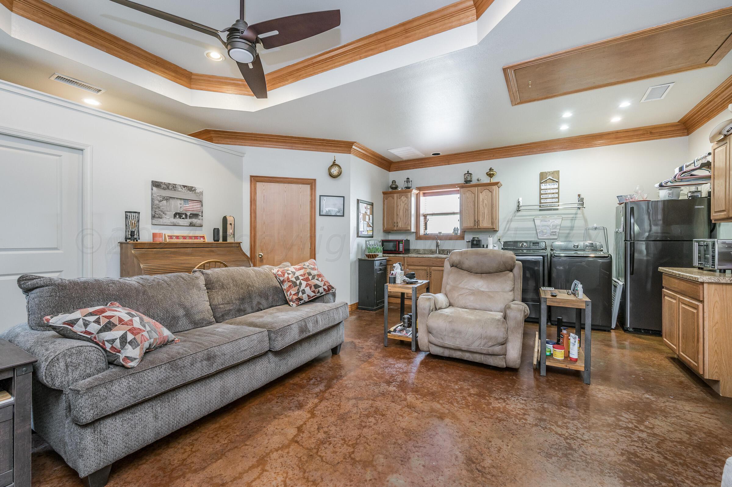 8921 Greyhawk Road Amarillo, TX 79119 - Photo 31 of 56 a living room with furniture and a view of dining room