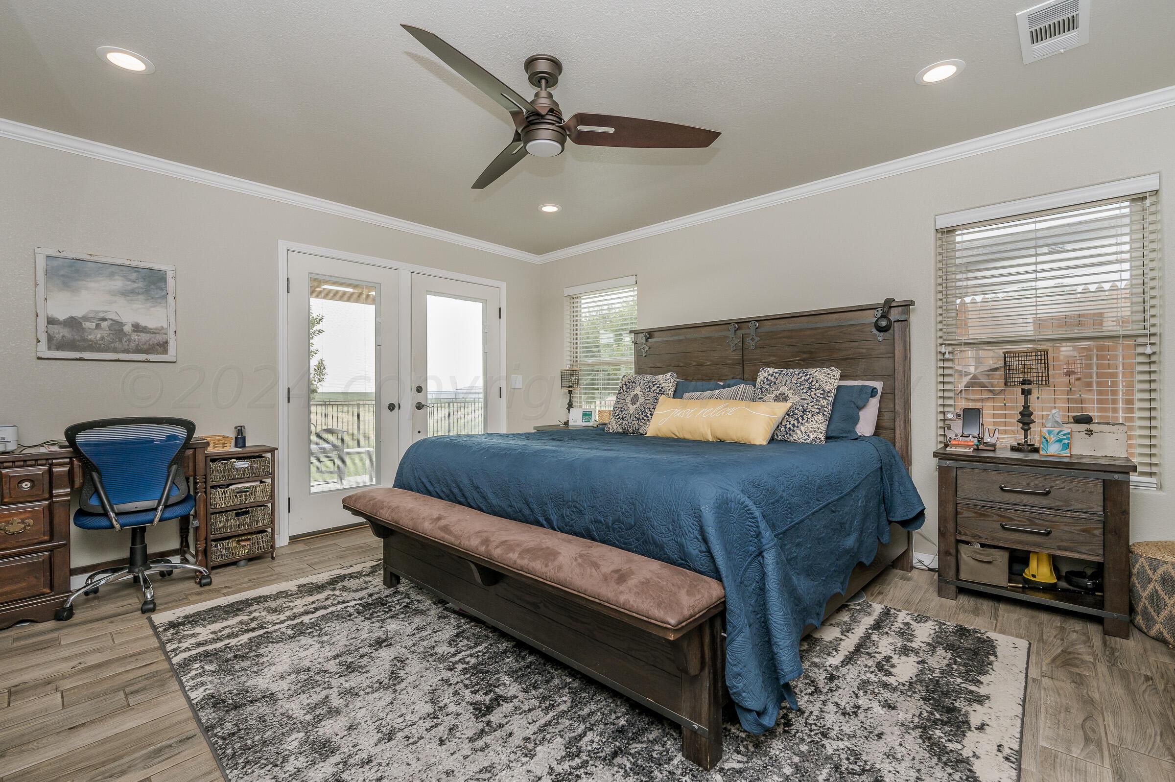 8921 Greyhawk Road Amarillo, TX 79119 - Photo 38 of 56 a bedroom with a bed a table and chair