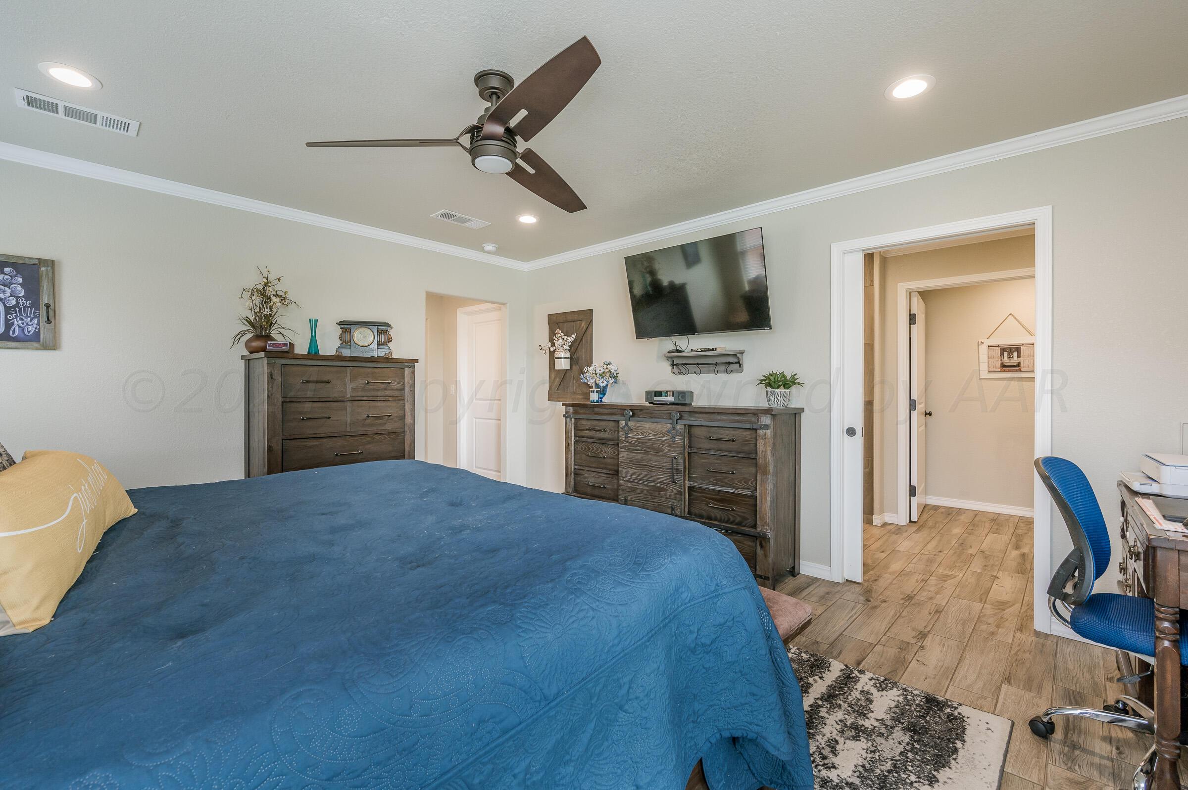8921 Greyhawk Road Amarillo, TX 79119 - Photo 39 of 56 a bedroom with a bed and a television