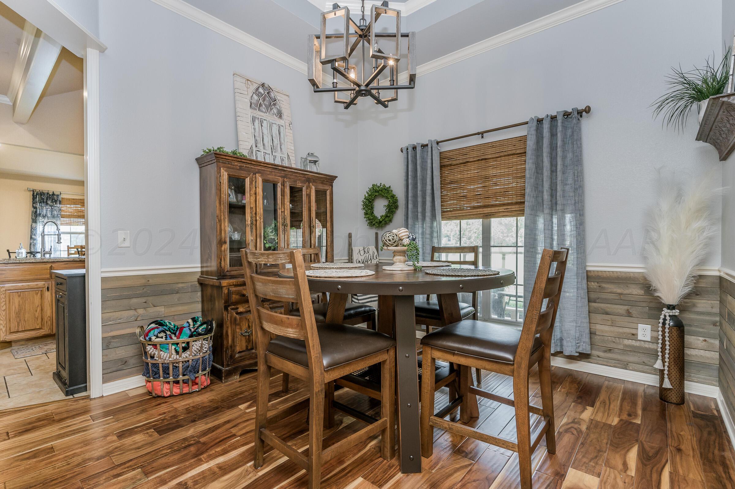 8921 Greyhawk Road Amarillo, TX 79119 - Photo 4 of 56 a view of a dining room with furniture window and wooden floor