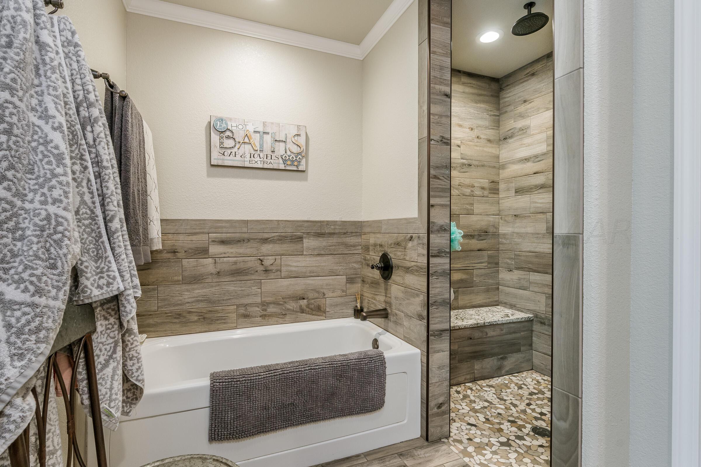 8921 Greyhawk Road Amarillo, TX 79119 - Photo 41 of 56 a bathroom with a bathtub and shower