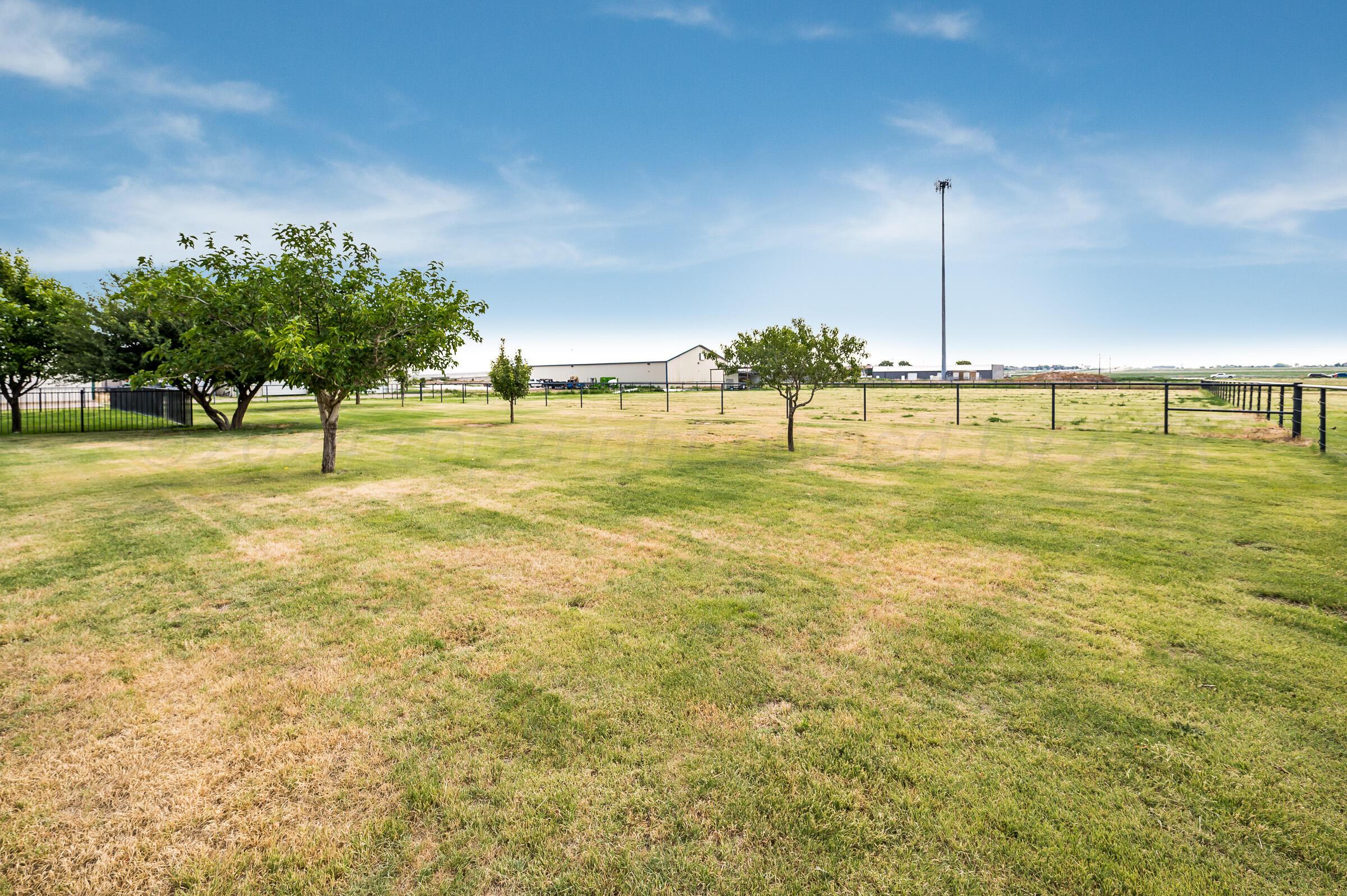 8921 Greyhawk Road Amarillo, TX 79119 - Photo 42 of 56 a swimming pool with lawn chairs