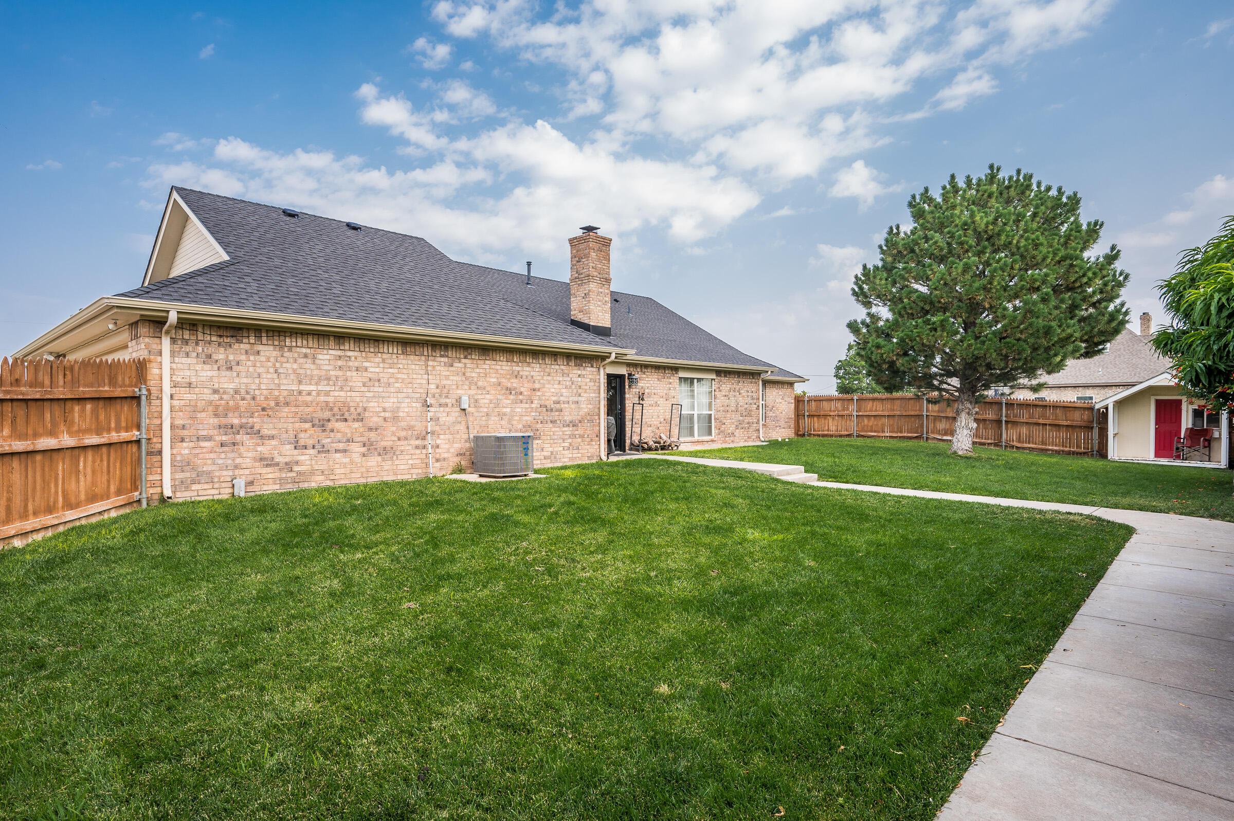8921 Greyhawk Road Amarillo, TX 79119 - Photo 43 of 56 a front view of a house with garden