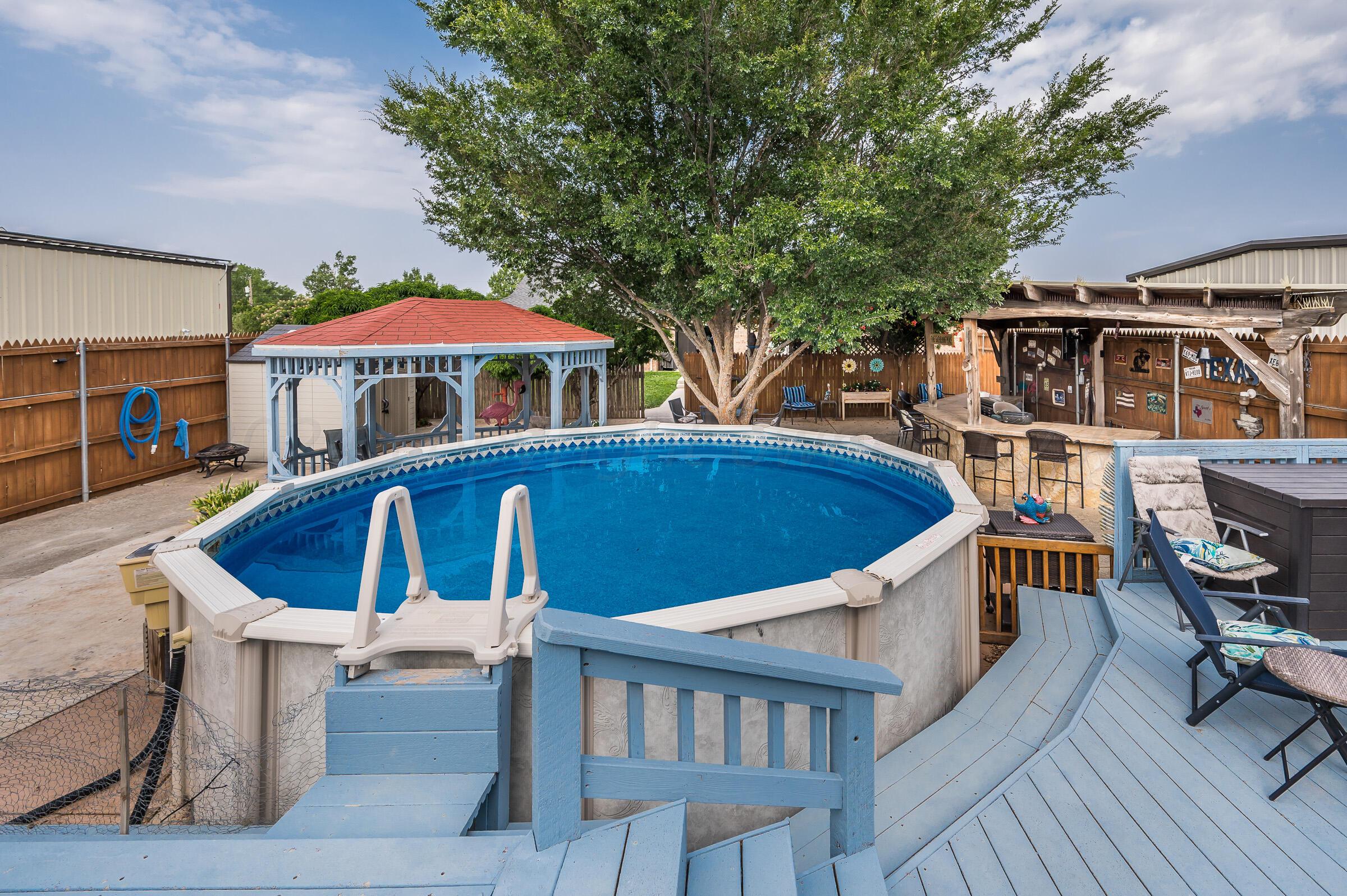 8921 Greyhawk Road Amarillo, TX 79119 - Photo 52 of 56 a view of a house with pool and chairs