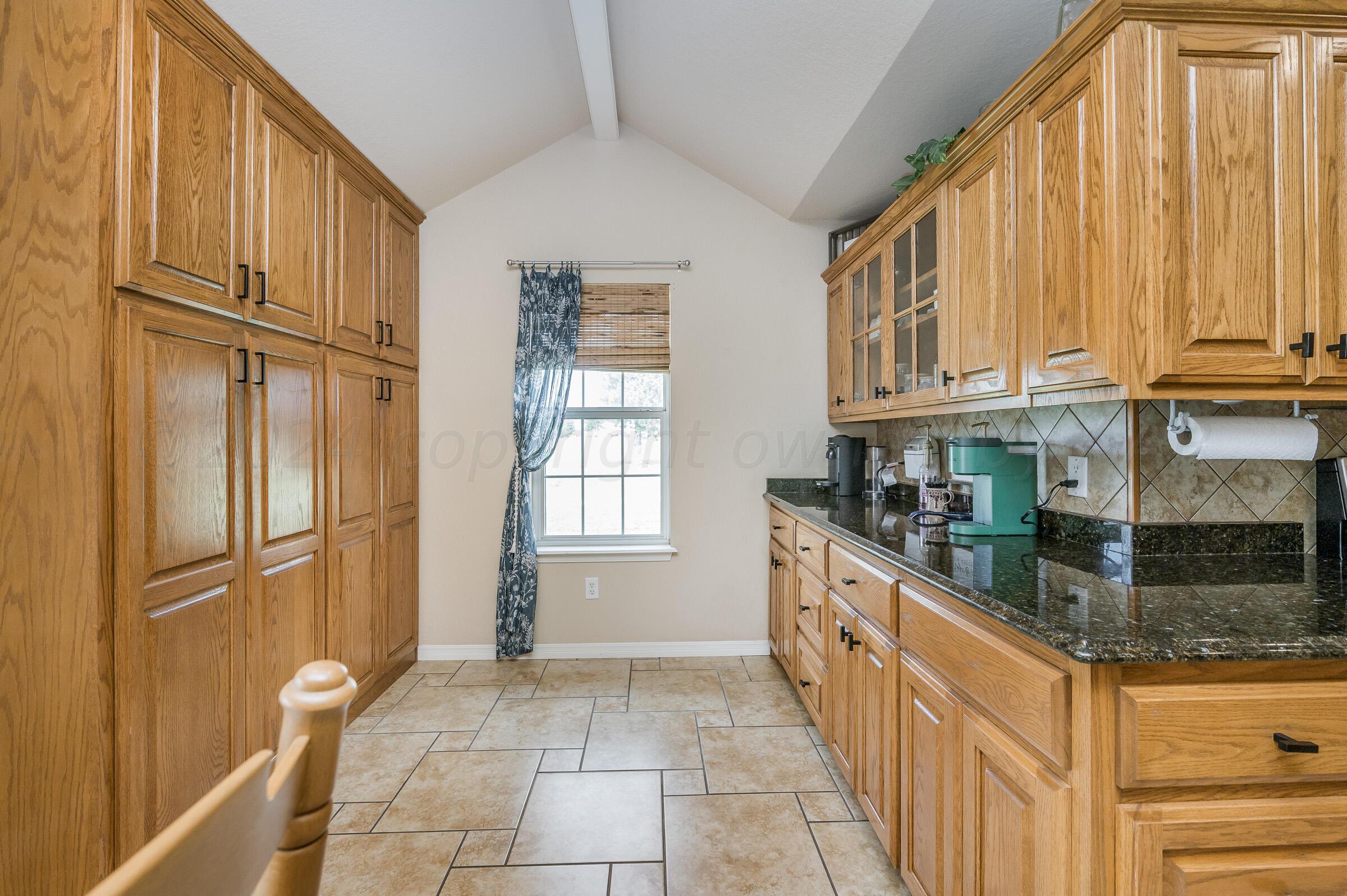 8921 Greyhawk Road Amarillo, TX 79119 - Photo 8 of 56 a kitchen with stainless steel appliances granite countertop a refrigerator and a sink