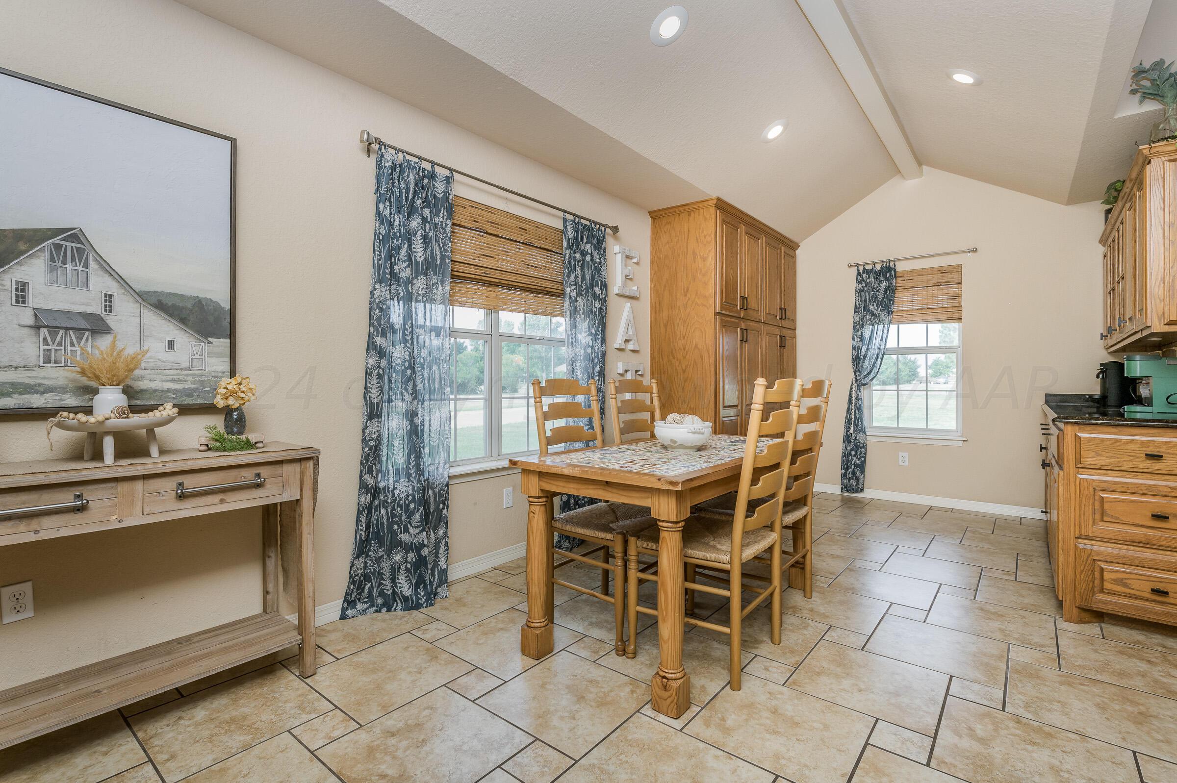 8921 Greyhawk Road Amarillo, TX 79119 - Photo 10 of 56 a dining table chair and fireplace