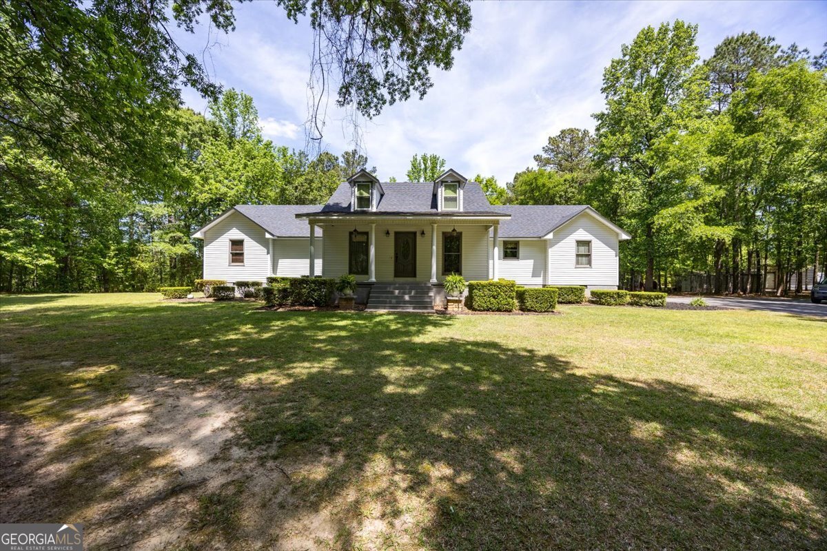 a front view of a house with garden