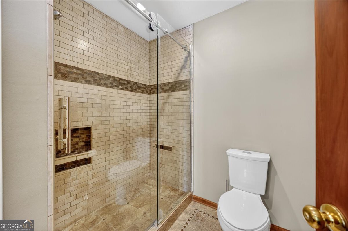 348 Craig Road Forsyth, GA 31029 - Photo 17 of 35 a bathroom with a toilet and a shower