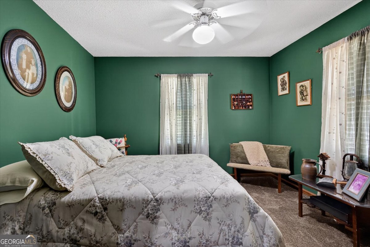 348 Craig Road Forsyth, GA 31029 - Photo 19 of 35 a bedroom with a bed and windows