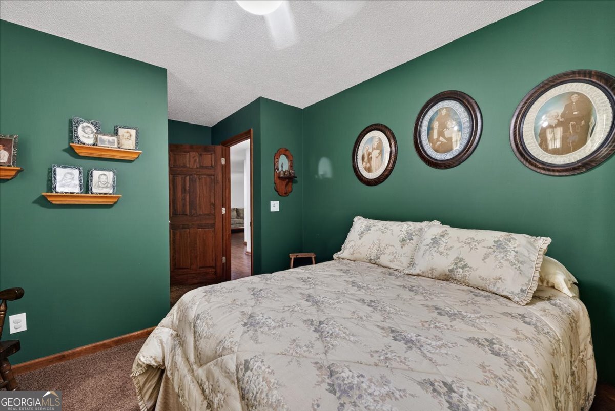 348 Craig Road Forsyth, GA 31029 - Photo 20 of 35 a bedroom with a bed and a clock on the wall