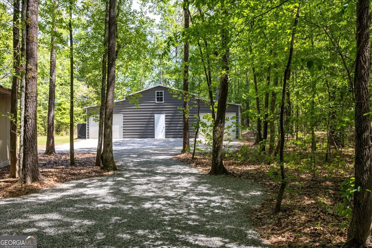 348 Craig Road Forsyth, GA 31029 - Photo 28 of 35 a dirt road with trees in the background
