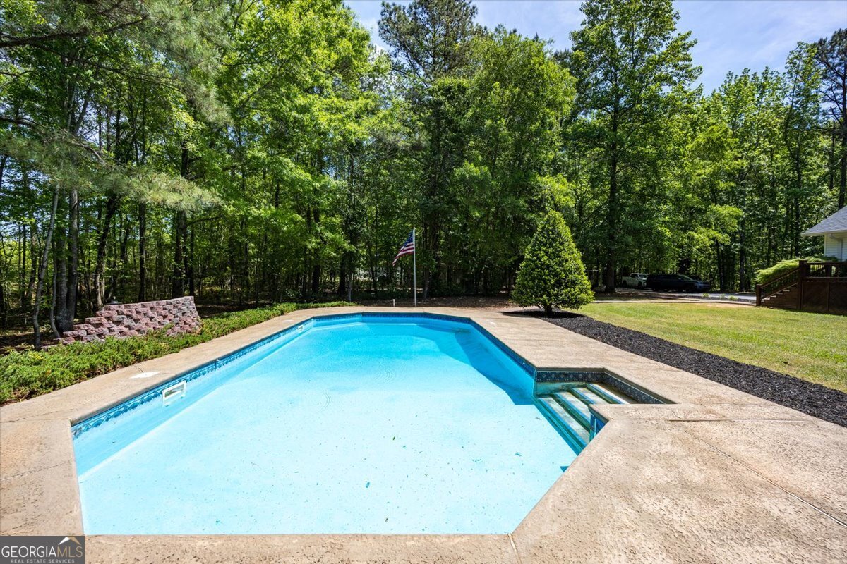 348 Craig Road Forsyth, GA 31029 - Photo 31 of 35 a view of a swimming pool with a yard