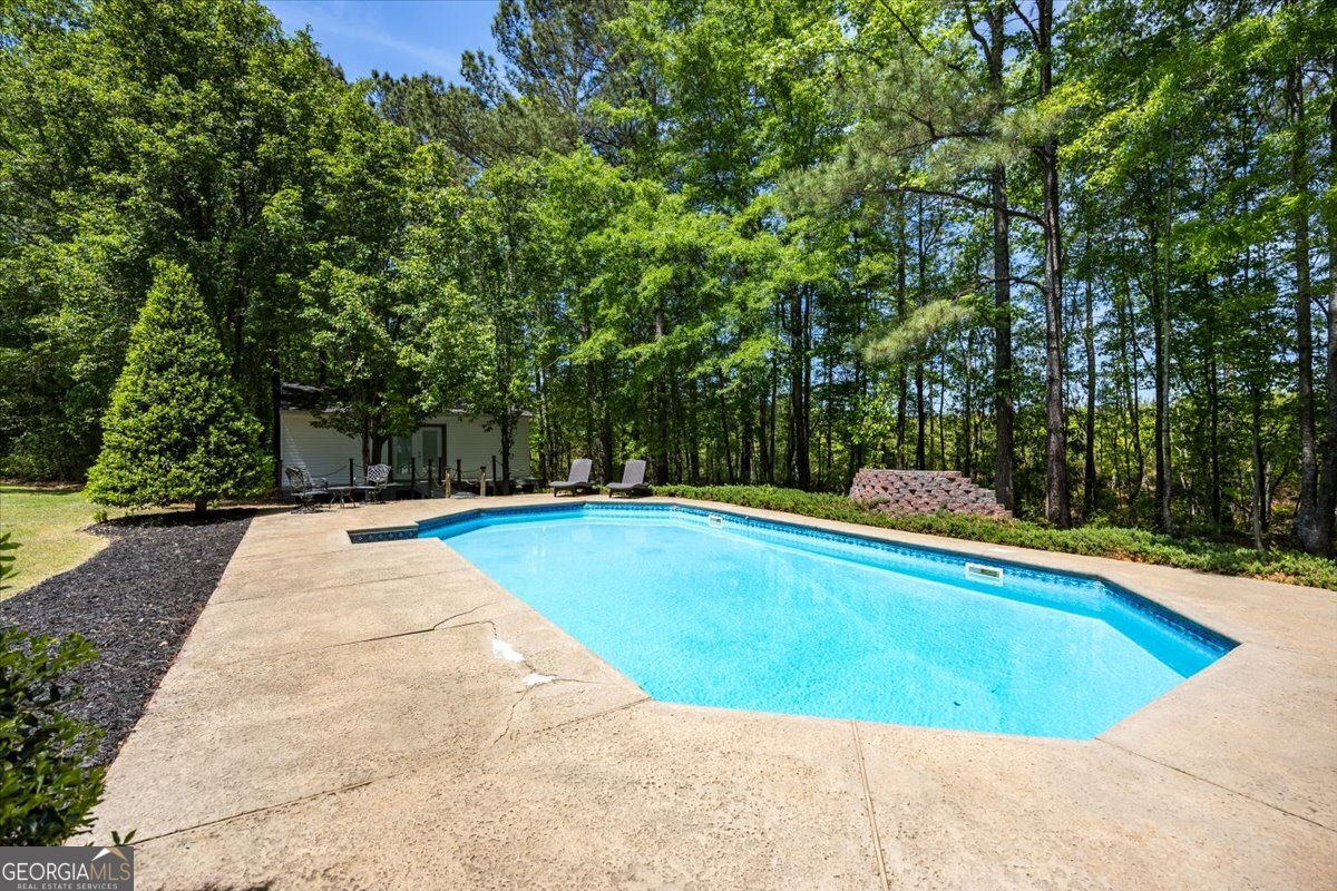 348 Craig Road Forsyth, GA 31029 - Photo 32 of 35 a view of a swimming pool and trees