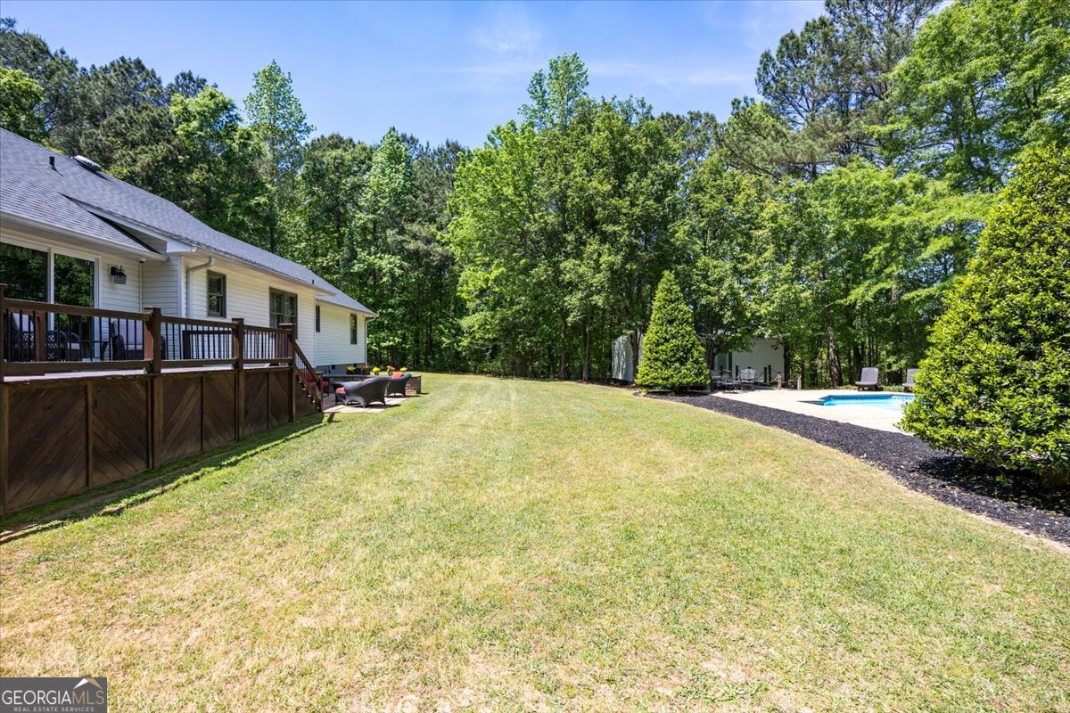 348 Craig Road Forsyth, GA 31029 - Photo 33 of 35 a swimming pool with trees in the background