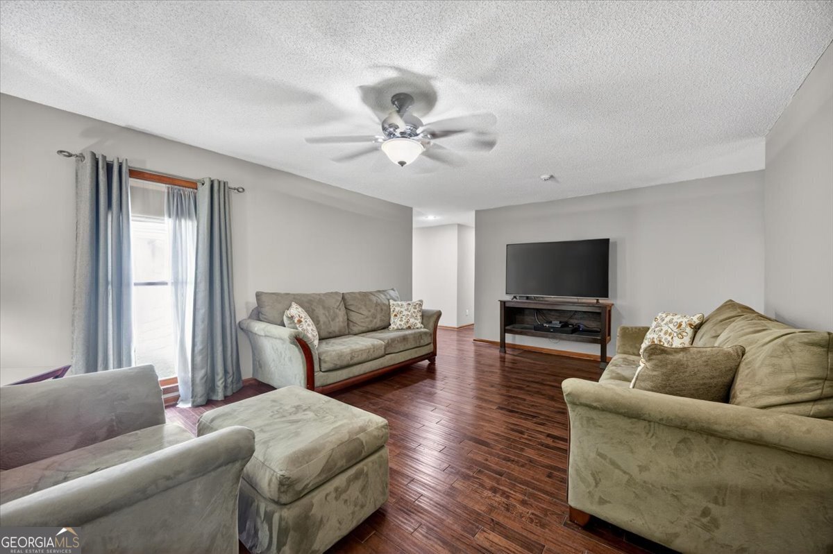 348 Craig Road Forsyth, GA 31029 - Photo 5 of 35 a living room with furniture and a flat screen tv