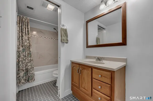 a bathroom with a sink a mirror and a shower