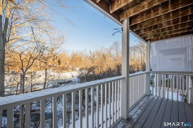 a view of balcony with wooden floor and fence