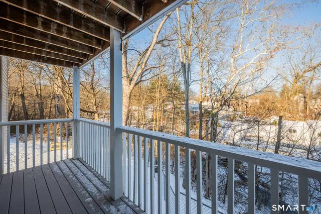 a view of a balcony with wooden floor