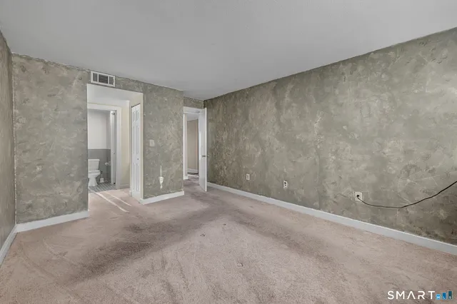 a view of an empty room and closet area