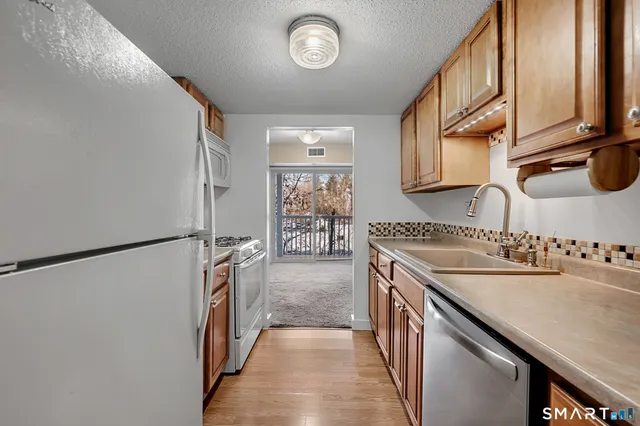 a kitchen with a refrigerator and a sink