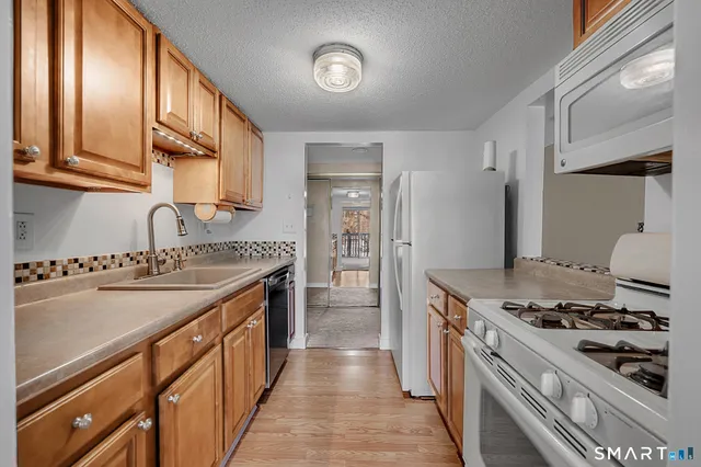 a kitchen with stainless steel appliances granite countertop a stove and a sink