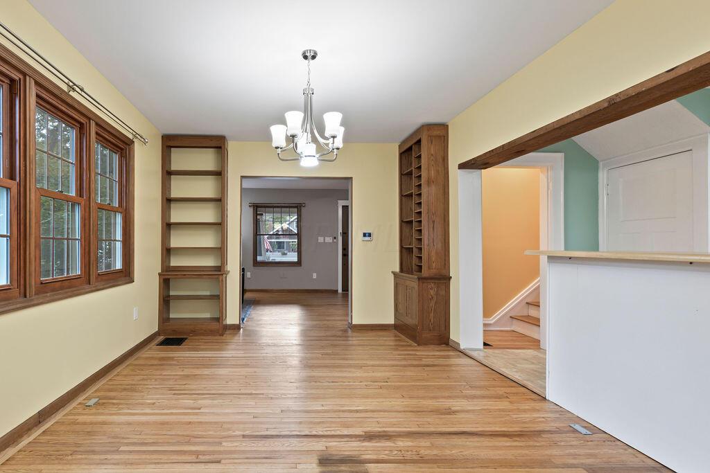 222 Brighton Road Columbus, OH 43202 - Photo 13 of 46 • Re-finished hardwood flooring 2023 • Chandelier lighting • 2 Built-in Shelves • Custard painted walls • Opens to Kitchen & 3-season room