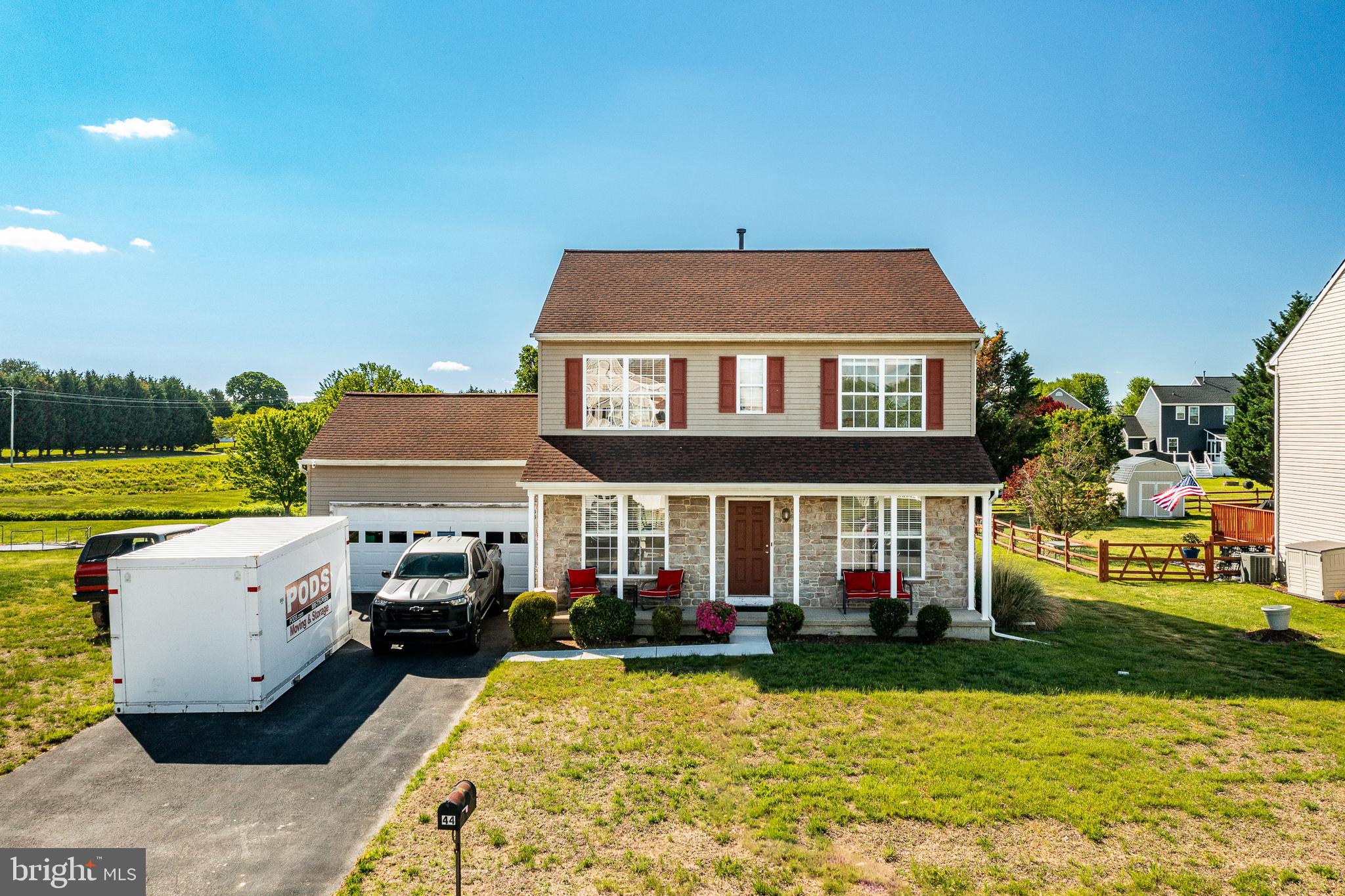 a front view of house with yard and car parked