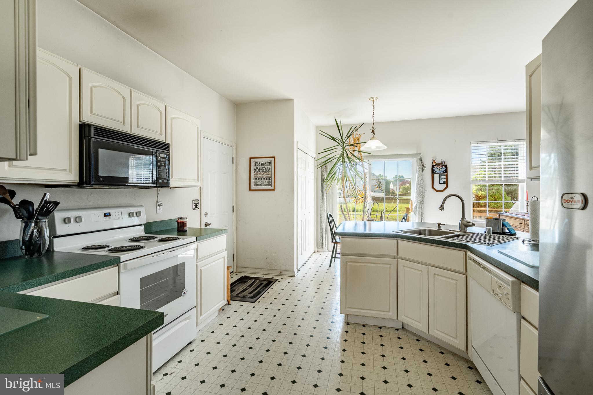 44 Ryhill Drive Dover, DE 19904 - Photo 11 of 53 a kitchen with stainless steel appliances a stove sink microwave and cabinets