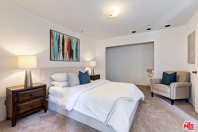 a bedroom with a bed and a lamp