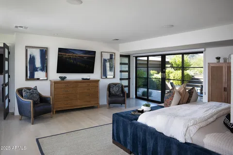 a spacious bedroom with a balcony a bed and a couch